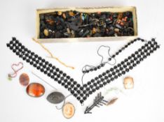 A collection of loose jet beads, French jet necklace, two cameo brooches, agate brooch, three