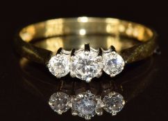 An 18ct gold ring set with three diamonds, the total diamond weight approximately 0.35ct, 2.2g, size