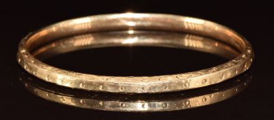 A 14k gold bangle with embossed scrolling and sphere decoration, 8.5g, 6.5 x 5.5cm