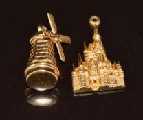 A 14k gold charm in the form of a windmill and a 14k gold charm depicting Walt Disney, 5.3g