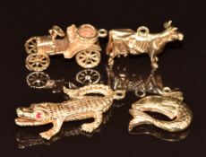 Four 9ct gold charms including crocodile, fish, cow and car, 12.9g