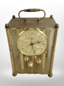 A Koma brass cased mantel timepiece,