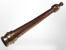 A copper and brass fire hose nozzle,