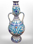 An Islamic style tin glazed fajence twin handled vessel,