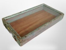 A glazed display cabinet with distressed painted frame,