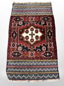 An Afghan rug of geometric design,