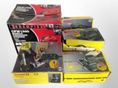 A group of boxed power tools, Bosch drill, sander,