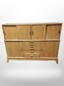 An early 20th century oak sliding door sideboard,