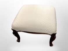 A large Victorian carved mahogany upholstered stool on cabriole legs,