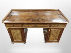 A 19th century Danish burr walnut twin pedestal writing desk on bun feet,