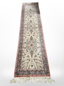 A machine made runner of Persian design 291 cm x 69 cm