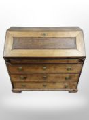 An early 19th century oak fall front bureau,