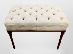 An Edwardian mahogany stool on turned reeded legs,