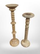 Two turned pine torcheres,