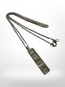 A silver ingot pendant on chain