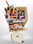 A Star Wars Millennium Falcon model and two boxes of assorted toy guns
