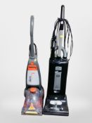A Sebo upright vacuum and Vax upright vacuum