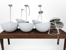 A group of eight white enamelled lamps