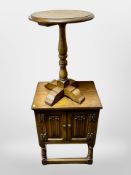 A contemporary oak linen fold oak cabinet and a further circular occasional table