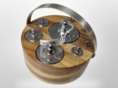 A circular wooden stand containing a set of graduated chrome weights ranging from 2lb to a 1/4oz.