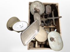 A vintage pine crate containing several sets of scales.