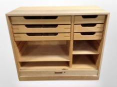 An early 20th century Danish oak shutter front office cabinet, shelved interior, with working key,