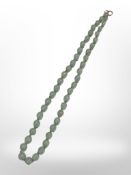A graduated jade bead necklace with yellow gold clasp, length 43 cm.
