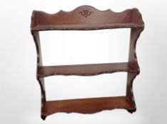 A reproduction mahogany three-tier wall shelf,