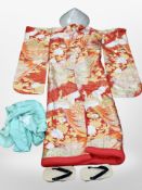 A group of oriental clothing including embroidered kimono, straw hat, sandals, etc.