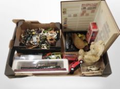A box containing diecast cars and model train, farm animals, a vintage teddy bear, a stamp album,