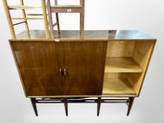 A 20th century Danish walnut sliding door sideboard, on tapered legs,