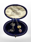 An old silver pendant and chain set with opal, ruby and diamond.