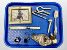 A silver-mounted picture frame together with a group of silver-plated wares, including nutcrackers,
