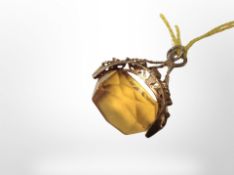 A 9ct gold fob with amber coloured faceted stone (6.6g).