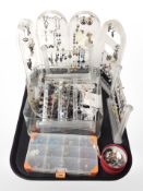 Several plastic jewellery stands containing costume earrings.