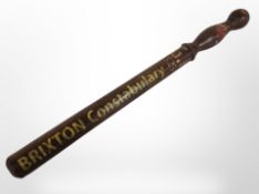 A turned wooden police truncheon with later decoration, length 51cm.