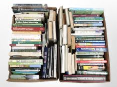 Two boxes of books relating to cricket.