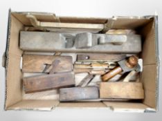 A box containing antique woodworking planes, spirit level, etc.