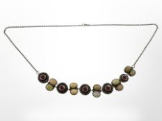 A silver necklace set with opal ruby and diamond