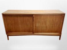 A 20th century Danish teak sliding door low sideboard,