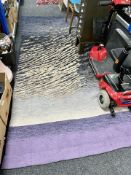 A contemporary rug on purple ground, 282cm x 122cm.