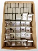 A large quantity of earring boxes, 22 of which contain silver earrings.