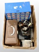 A box containing fishing reels, bait box, hip flask, fisherman's multi-draw storage chest, etc.