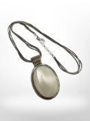 A silver pendant and chain