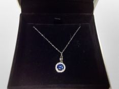 A silver blue and white stone pendant on chain