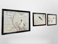Three Japanese silkwork panels depicting birds perched on branches, largest 69 cm x 53 cm.