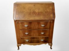 A 1930's walnut veneered three fall front bureau,