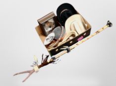 A box containing Native American-style staff, framed picture, two cowboys lassoes, two cowboy hats,