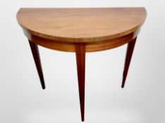 A walnut demi lune table,