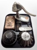 A group of vintage kitchenalia, including jelly moulds, pastry knife, grater, mincer.